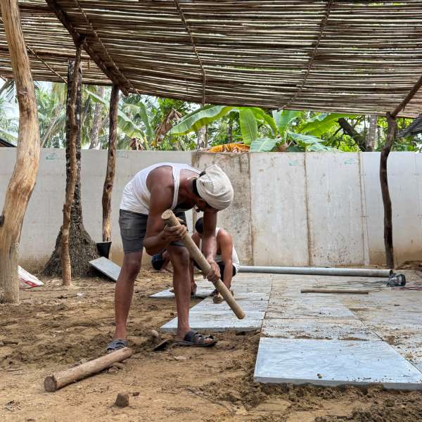 Laying tiles for the floor of the new café at Luma Goa
